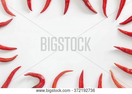 A Lot Of Red Hot Chili Peppers On A White Background. A Concept Hot Spice For Food. Top View, Flat L
