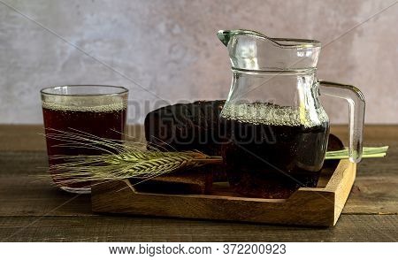 Traditional Rye Bread Kvass In The Wooden Tray. Selective Focus.kvass