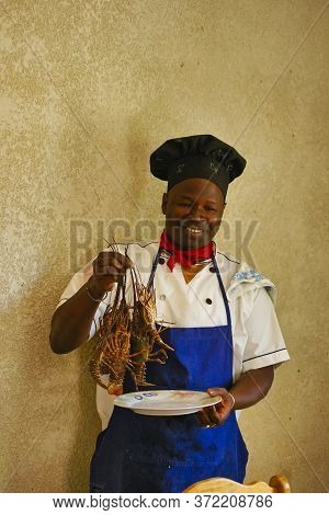 Senegal, Africa - Marsch Circa, 2016. Unidentified Chef Cooker Holding Big Gambas, Just Before Cooki