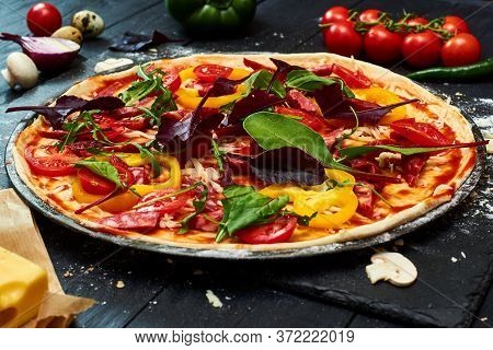 Raw Pizza With Mozzarella Cheese, Meat, Tomatoes, Mushrooms, Peppers, Herbs On A Dark Wooden Backgro