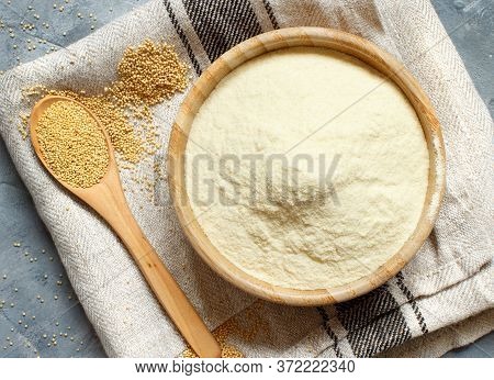 Bowl Of Raw Amaranth Flour With A Spoon Of Amaranth Seeds On A Napkin Top View