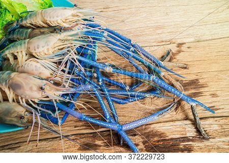 Top Down Fresh Tiger Prawns In A Plate With Ice On A Wooden Textured Background Shrimps Or Prawn Raw