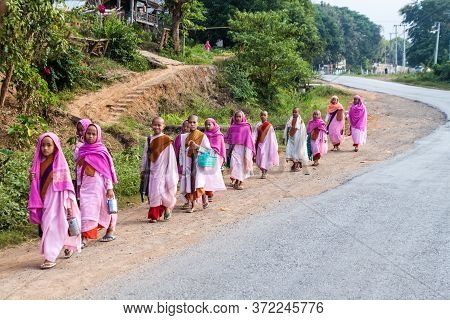 Hsipaw, Myanmar - December 1, 2016: Young Buddhist Nuns Go For Morning Alms In A Village Near Hsipaw