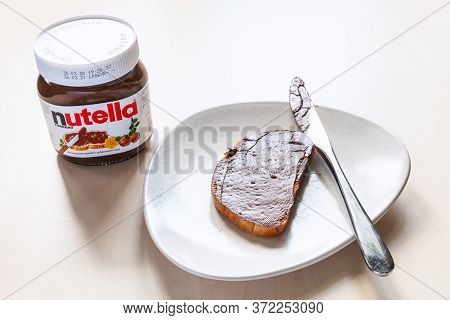 Moscow, Russia - June 16, 2020: Glass Jar Of Nutella And Toast With Sweetened Hazelnut Cocoa Spread 