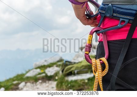 Unrecognizable Woman Rock Climber Wearing In Safety Harness With Quickdraws And Climbing Equipment O