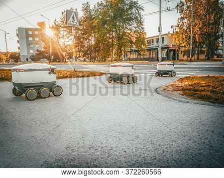 Some Delivery Robots On The Street. Estonian Cyber-couriers In Tallinn City. Sunny Summer Day. Copy 