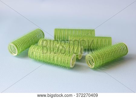Hair Culers On The Blue Backround. Green Culers For Hairdress. Top View. Flat Lay.