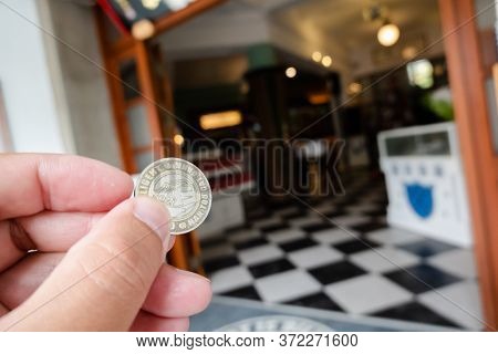 Nantou, Taiwan - December 18th, 2019: coins as a ticket at Nantou Cat Bank, Nantou, Taiwan, Asia