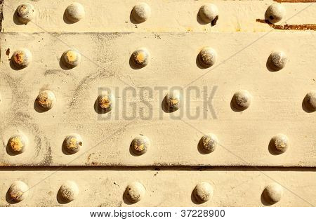 ผิวโลหะด้วย rivets อาจใช้เป็นพื้นหลัง