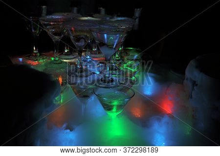 Pyramid Of Glasses With Light.and Smoke From Dry Ice