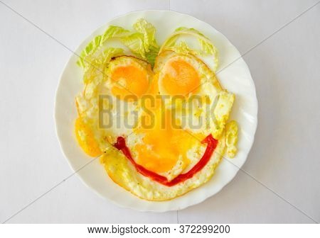 Scrambled Eggs With A Smile On Plate