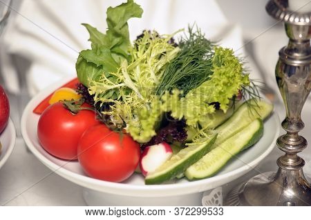 Salad With Lettuce And Cucumber, Arugula And Cherry Tomatoes