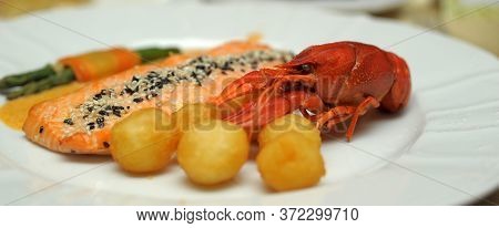 Boiled Crawfish And Potatoes On White Plate
