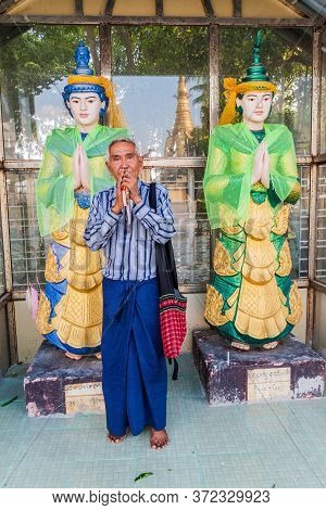 Yangon, Myanmar - December 15, 2016: Local Man Performing A Ritual At Botataung Paya Pagoda In Yango