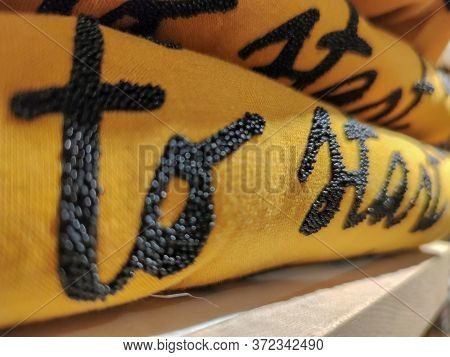 A Yellow Sweater Folded On The Shelf