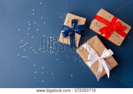 Red, Blue And White Gift Boxes On Classic Blue Background In The National Colors Of America, Russia,
