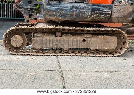 Excavator Tracks. Old Iron Caterpillars Of The Bulldozer Of The Tractor On The Road. Bulldozer Cater