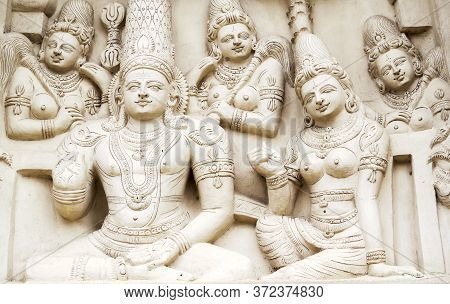 Sculptural Images Of Shiva And Parvati In Accompaniment Of The Retinue On The Wall Of An Ancient Ind