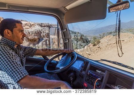 Hajar Mountains, Oman - March 2, 2017: Driver Of A Water Tank Truck In Hajar Mountains, Oman