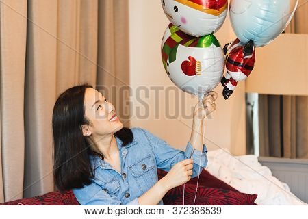 Happy Woman With Smile Holding Balloon As A Present For Special Day At Home.