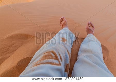Legs Of A Man In The Sand Dunes Of Sharqiya Wahiba Sands, Oman