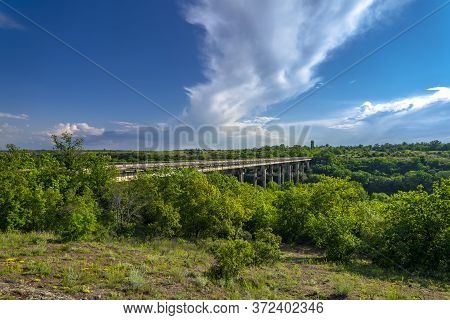 Ancient Old Bridge Over Southern Bug. Yuzhny Buh River Flow Through Green Trees. Nature Landscape