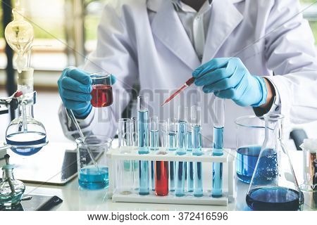 The Scientist Doing Chemical Experiment In Order To Develop Products With Quality And Effectiveness 