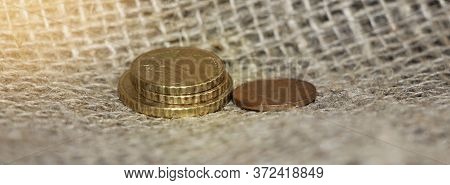 Some Euro Coins On Burlap Canvas Background. Little Money Concept. Powerty Concept