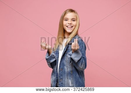 Smiling Little Kid Girl 12-13 Years Old In Denim Jacket Isolated On Pastel Pink Wall Background. Chi