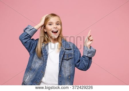 Amazed Little Blonde Kid Girl 12-13 Years Old In Denim Jacket Isolated On Pastel Pink Background In 