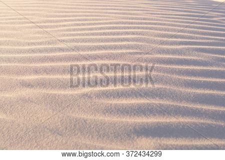 Sand Dunes And Ripples In The Desert On A Clear, Sunny Day