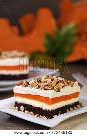 Pumpkin Pie - Light, Creamy Dessert With Cheese Cream And Pumpkin Layers Topped With Chopped Nuts