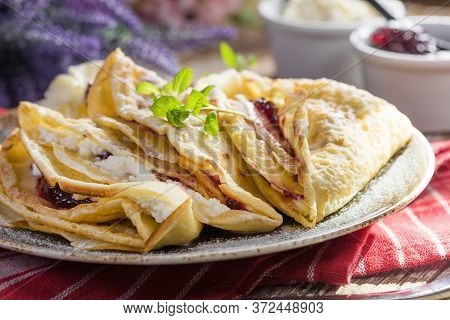 Crepes With Ricotta Cheese And Blackcurrant Jam. Delicious Crepes, Thin Pancakes.
