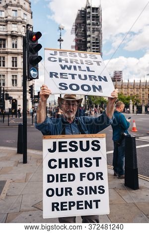 London / Uk - 06/20/2020: Street Preacher Outside The British Parliament Stating Jeus Christ Will Re