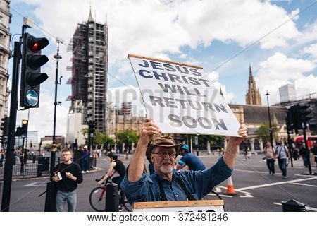 London / Uk - 06/20/2020: Street Preacher Outside The British Parliament Stating Jeus Christ Will Re