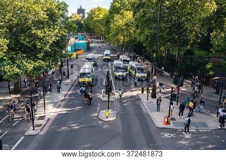 London / Uk - 06/20/2020: Police Vans Going To Trafalgar Square Behind The Huge Crowd Of Blm Protest