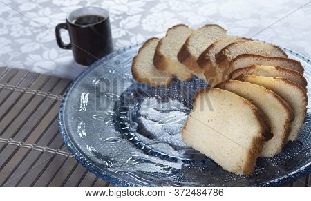 Slices Of Cake And A Cup Of Coffee On A Plate Well Assembled On A Table.