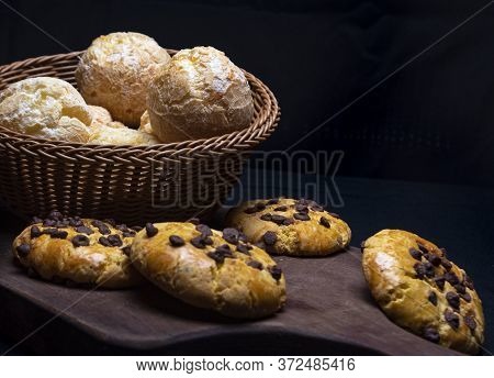 Beautiful Loaves And Pastries In Low Light On Black Background