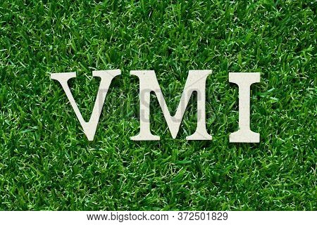 Wood Alphabet Lette In Word Vmi (abbreviation Of Vendor Managed Inventory) On Gree Grass Background
