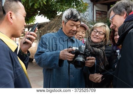 Yunnan, China February 2019. Inhabitants Of A Rural Village Amazed By The Presence Of Western Touris