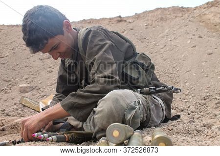 A Child Fighter Supplies Ammunition To His Comrades
