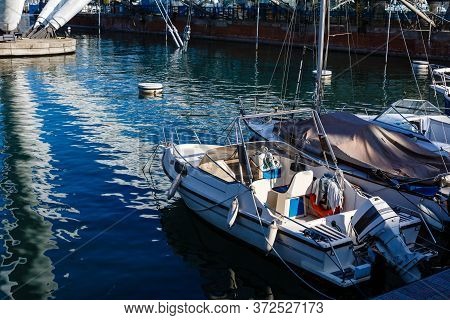Yacht In Port Near The Pier. Speed Boat Mooring. Boat Parking Boating Yachting Equipment.