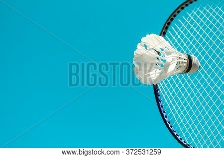 Modern Minimalist Image Of A Badminton Set With Rackets And A White Projectile With Dark Shadows