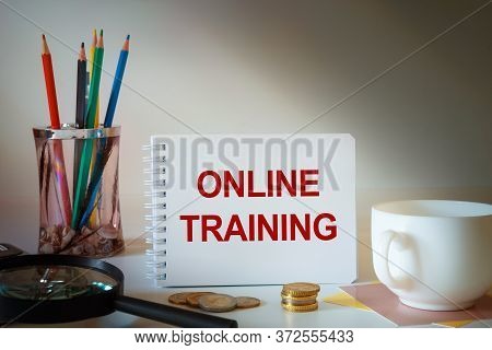 Desktop With Documents, Calculator And Notebook. On A Blockboard Inscription Online Training