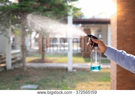 Young Man Uses A Spray Of Alcohol To Get Rid Of Bacteria And Viruses, Inhibition And Prevention Of C
