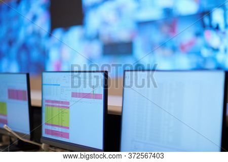 Empty interior of big modern security system control room, workstation with multiple displays, monitoring room with at security data center  Empty office, desk, and chairs at a main CCTV 