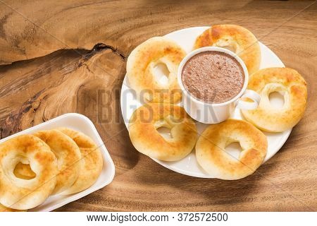 Pandequeso Traditional Colombian Food - Hot Drink Chocolate. Wood Background