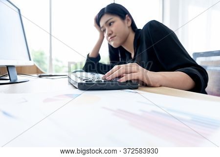 Blurred Soft Images Of Asian Businesswoman Is Working By Using A Computer With Boredom At Workplace,