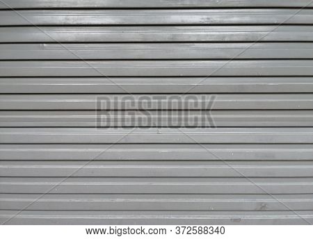 Perforated Metal Garage Door Texture Background. Copy Space.