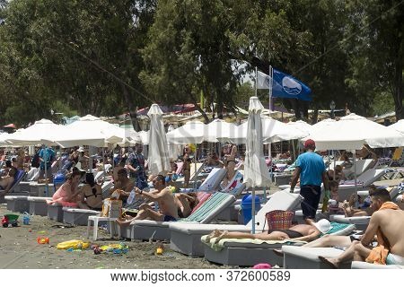 Limassol, Cyprus, June 21st, 2020: Crowded Dasoudi Beach With The Flag Of Germasogeia Municipality A